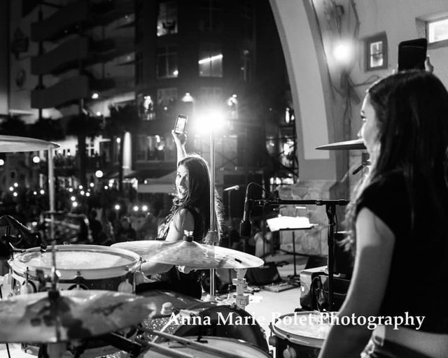 Autumn performing on stage with her band at night