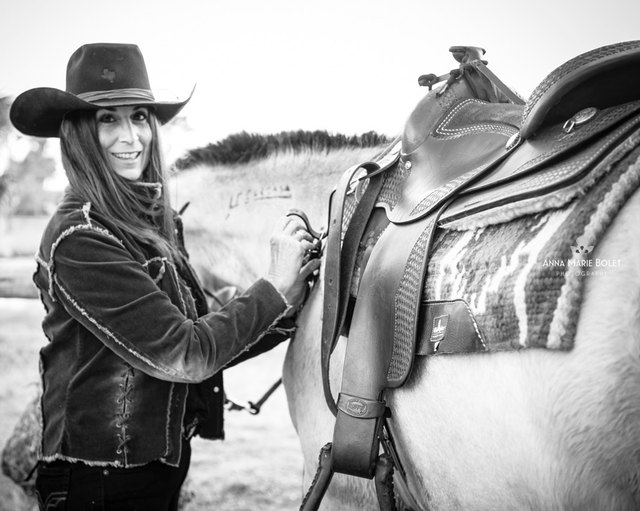Autumn saddling a horse, black-and-white portrait